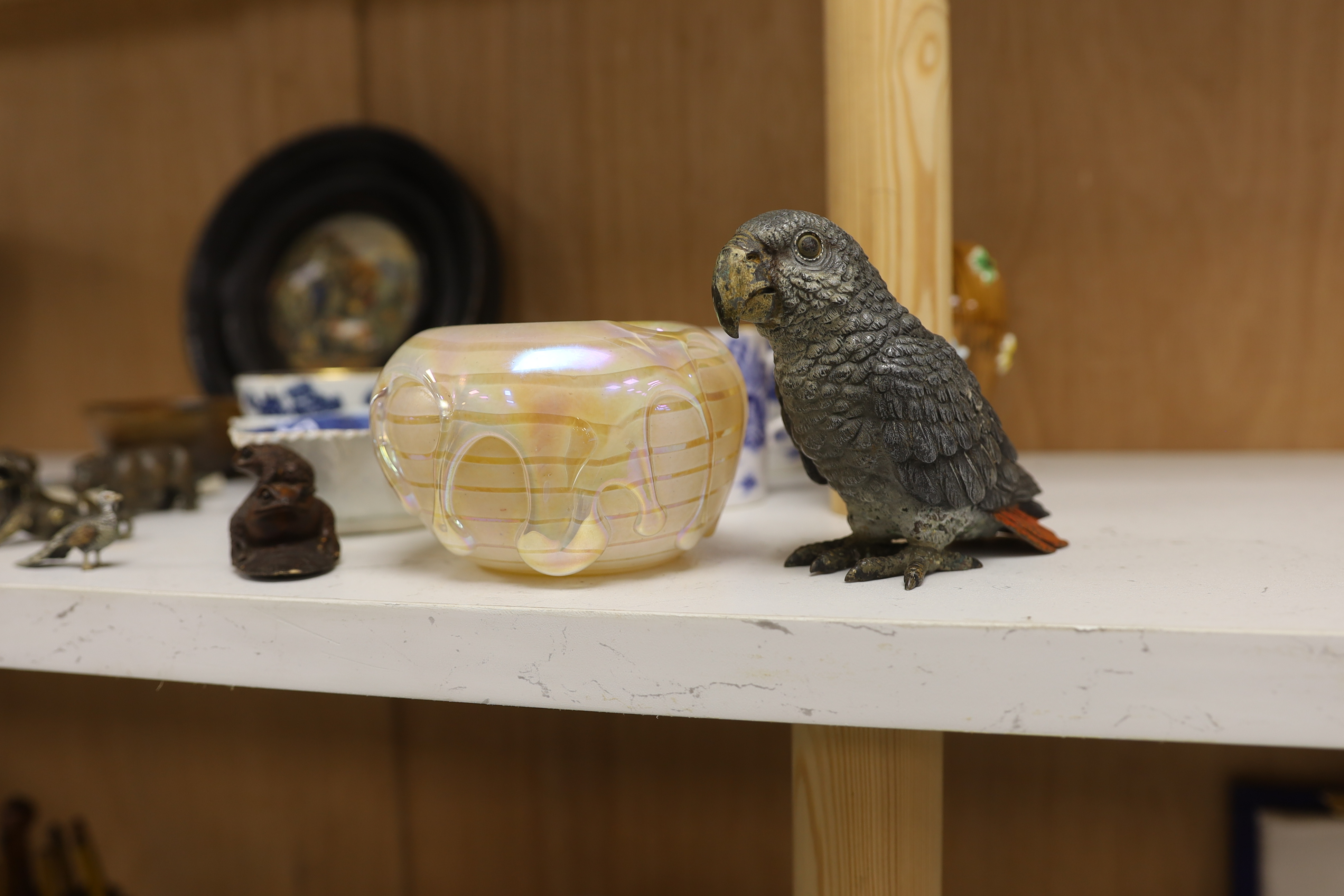 An early 20th century Viennese cold painted bronze figure of an African grey parrot, two 18th century English coffee cups, a leaf shape pickle dish, Victorian pot lid, other metal animal figures, a Japanese small carved